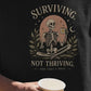 Surviving Not Thriving Skeleton Illustration Unisex T-Shirt | Funny Tired Burned Out Humor Shirt